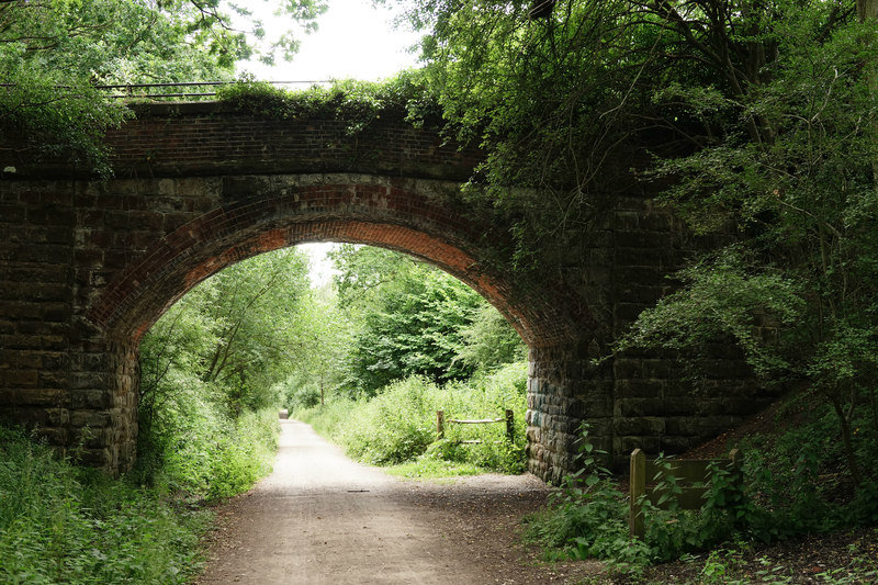 The Vanguard Way footpath passing under a stone bridge.